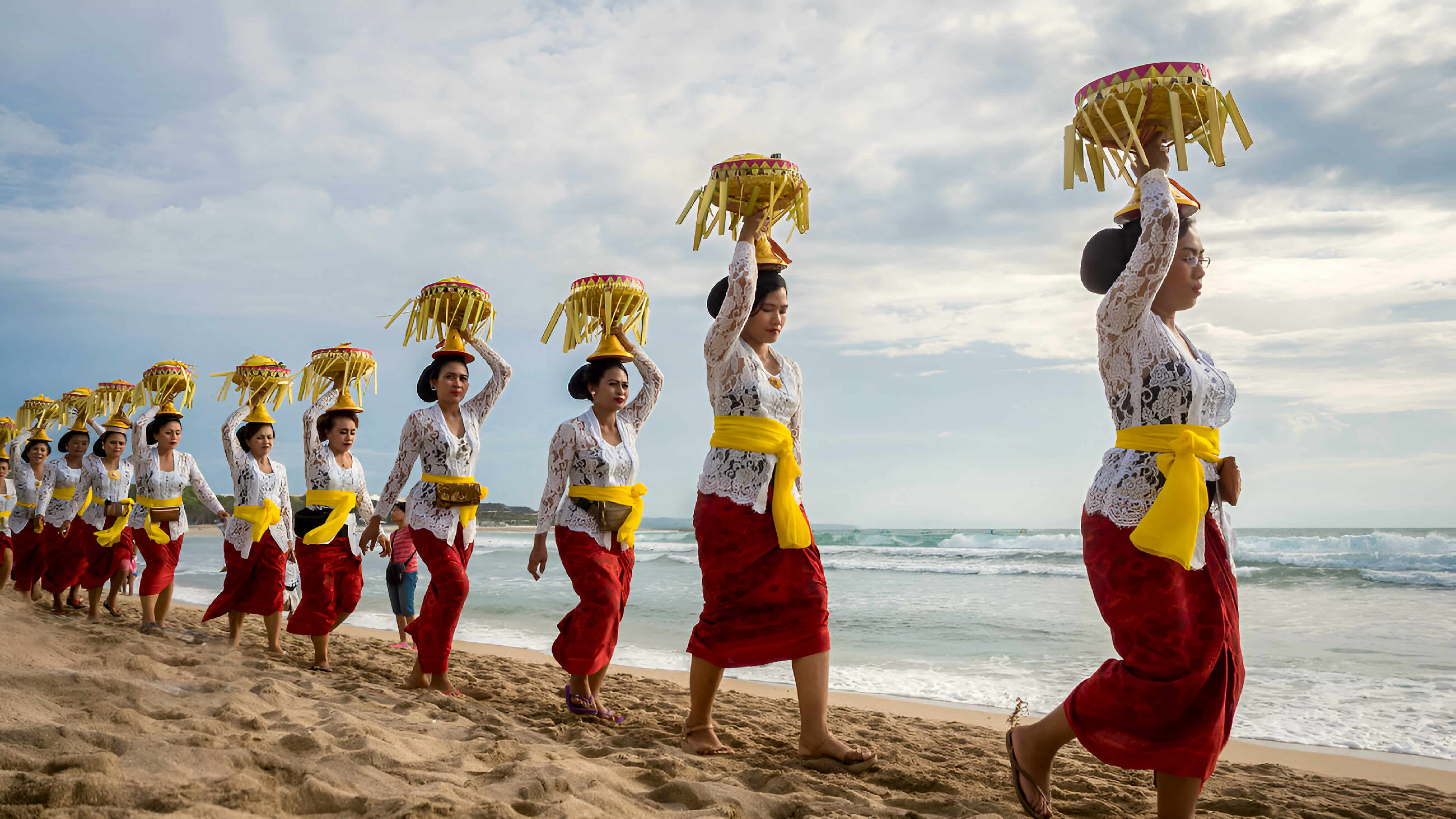 Balinese women carrying offerings at Melasti ceremony before Nyepi Balinese women carrying offerings at Melasti ceremony before Nyepi